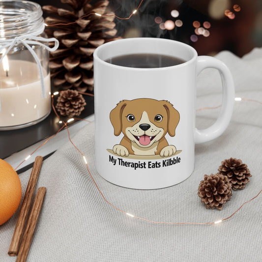 White mug with a dog illustration and text, surrounded by decorative items on a table.