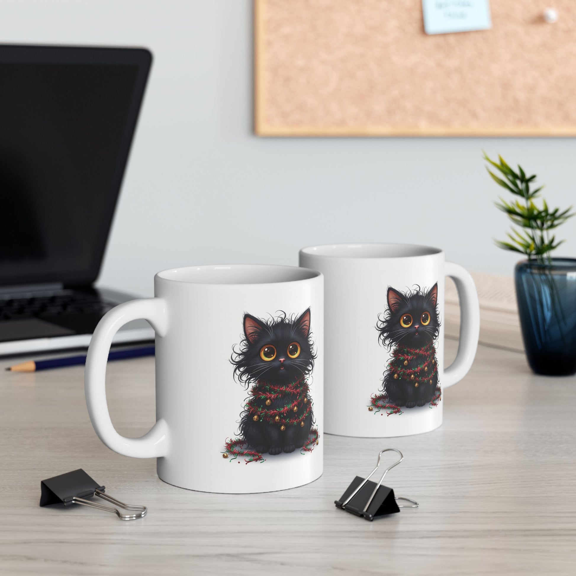 Two mugs with black cat illustrations on a desk with office supplies.