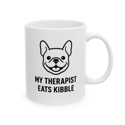 White mug with a dog illustration and text 'My Therapist Eats Kibble' on a white background
